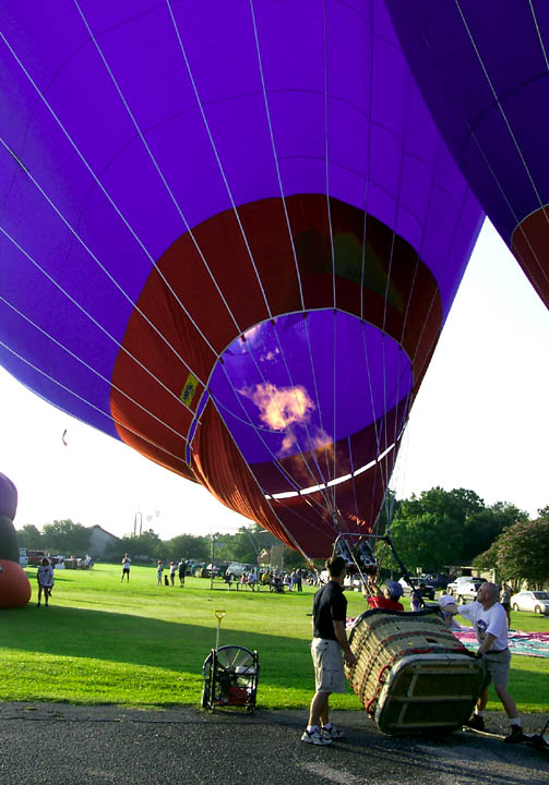 Flames shoot up into the balloon to heat the air inside making it lighter than the surrounding air.