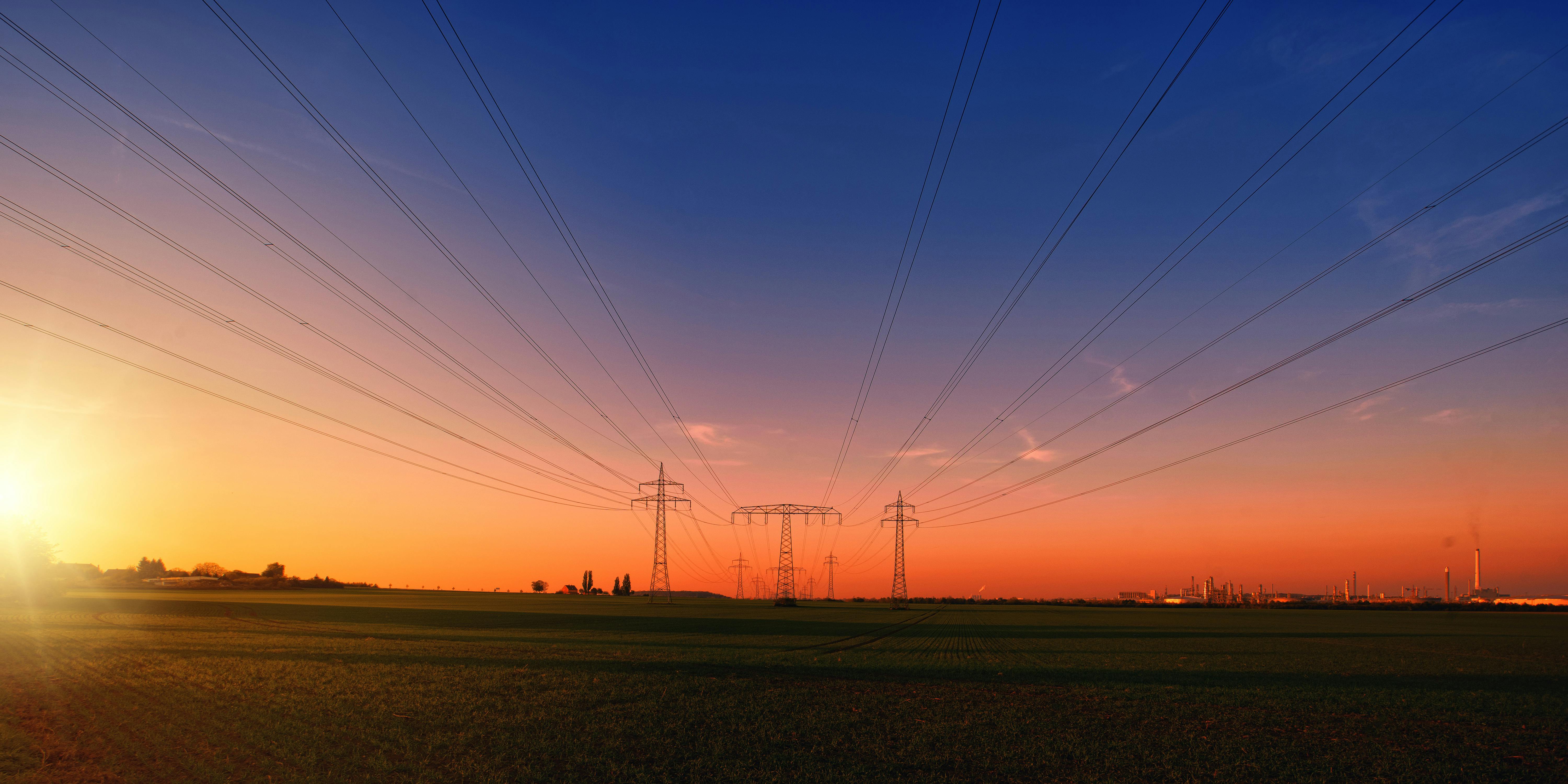 photography of electrical towers in the field