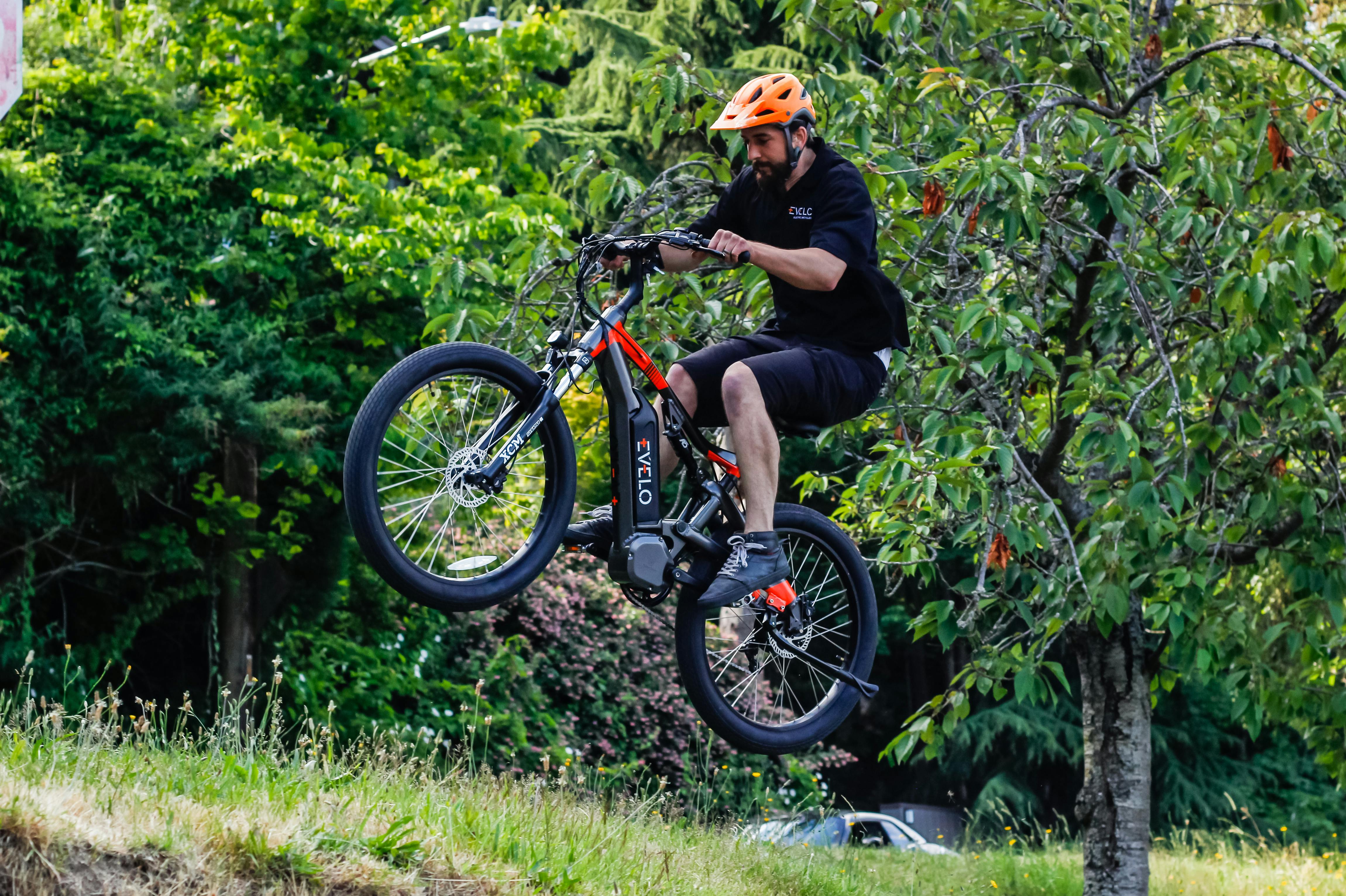 a man riding a dirt bike over a hill