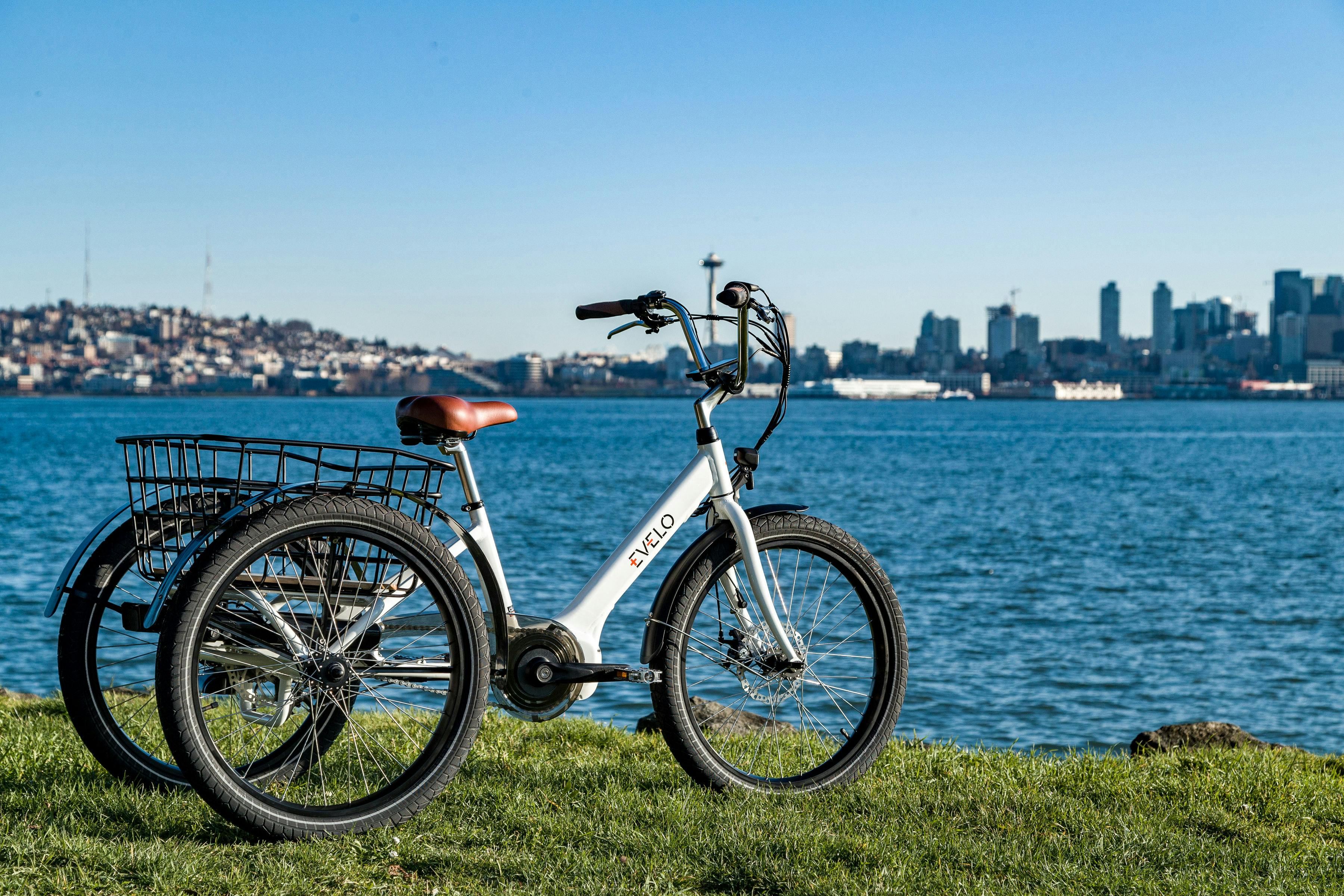 a bicycle with a basket on the front and a view of the city