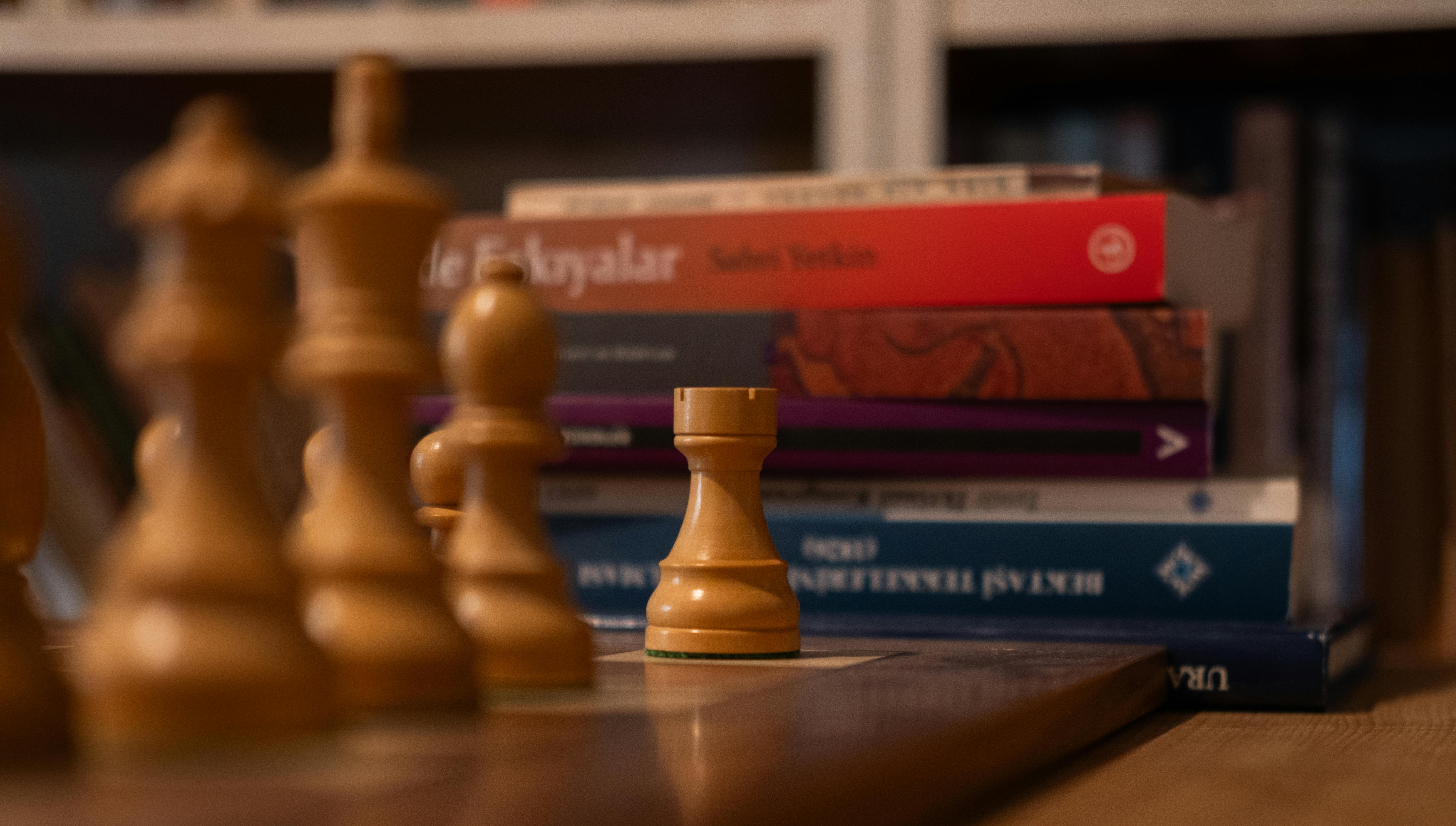 chess pieces and books in cozy library