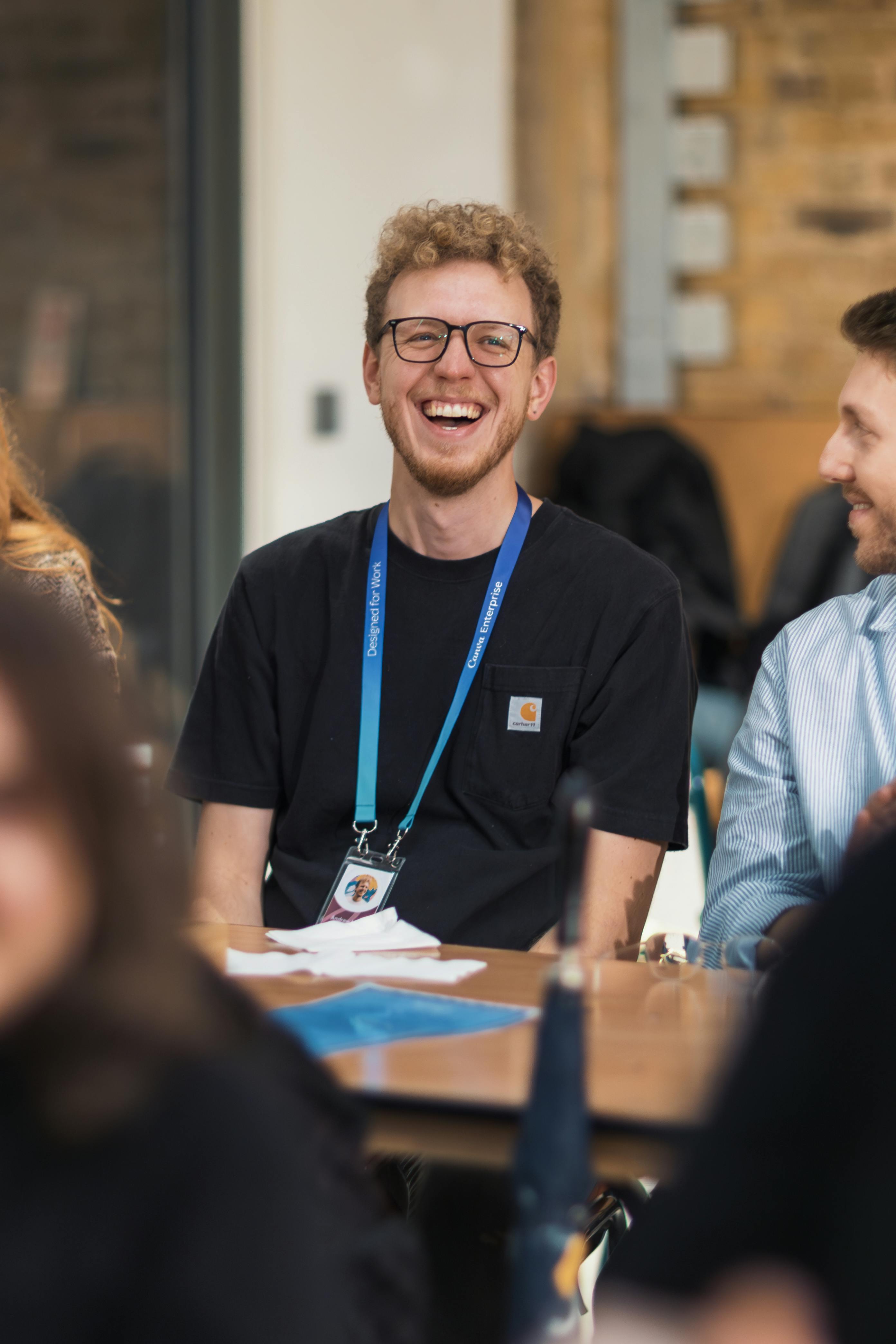 cheerful young man laughing at meeting