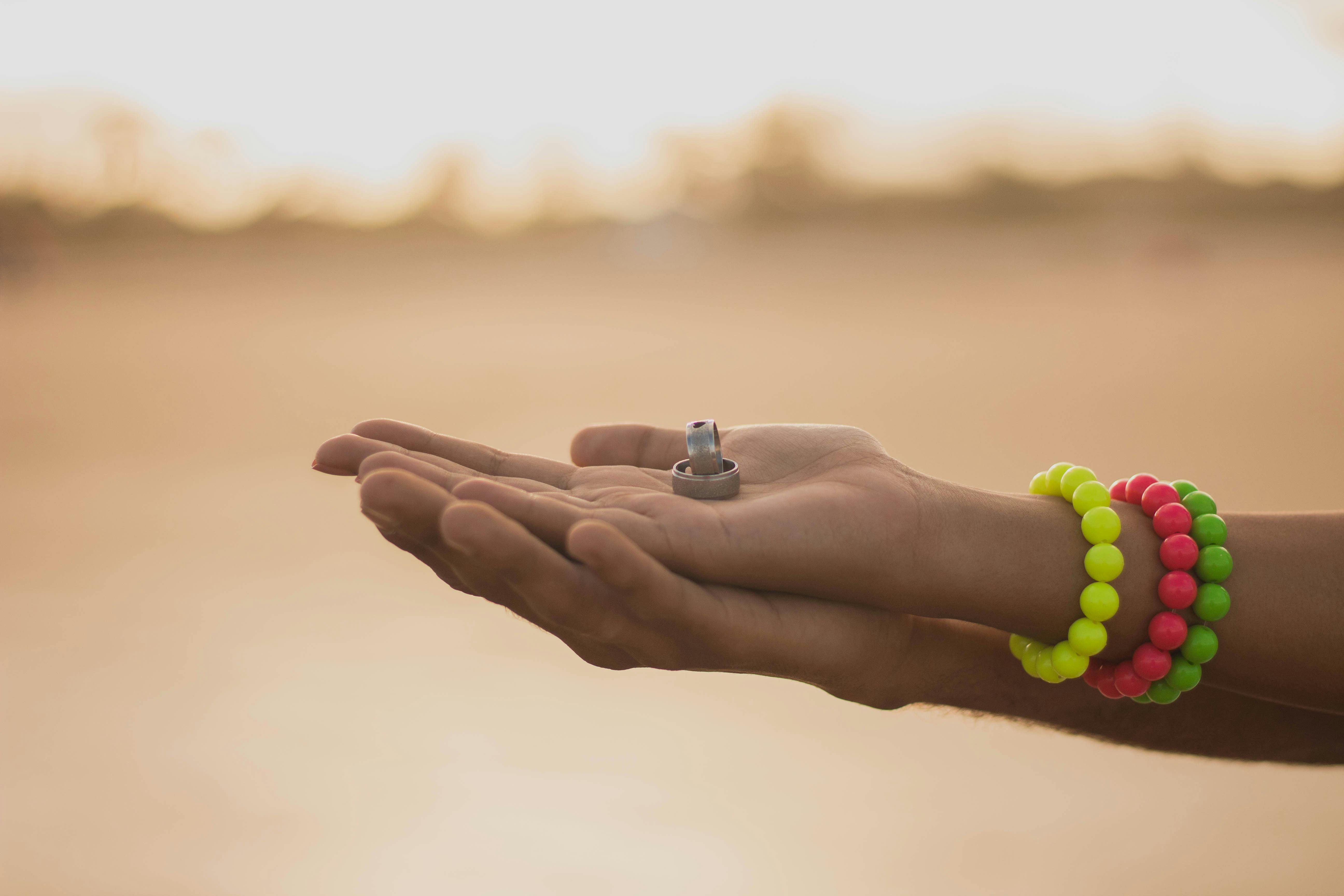 photo of wedding bands on person s hand
