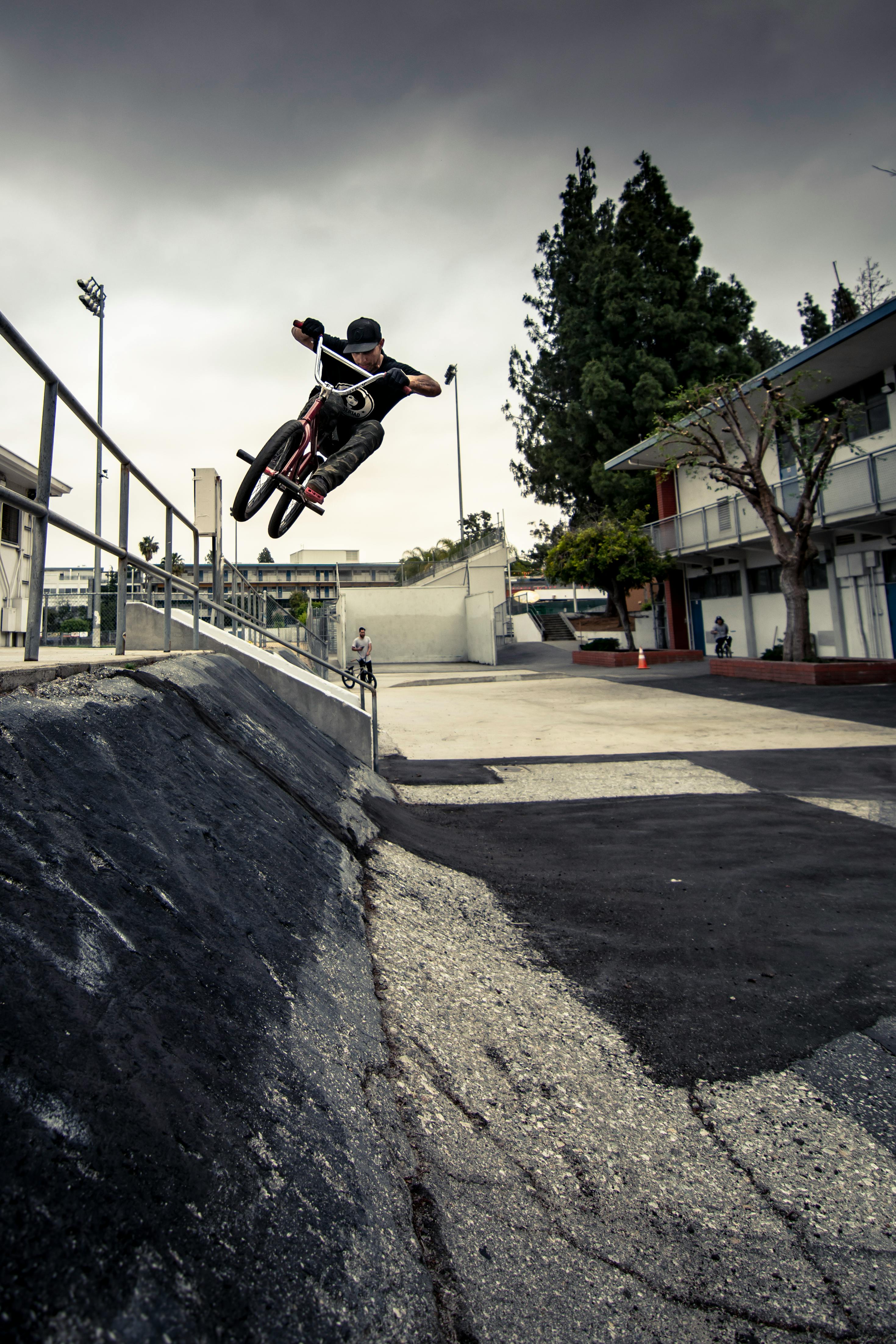 man doing a jump on a bicycle