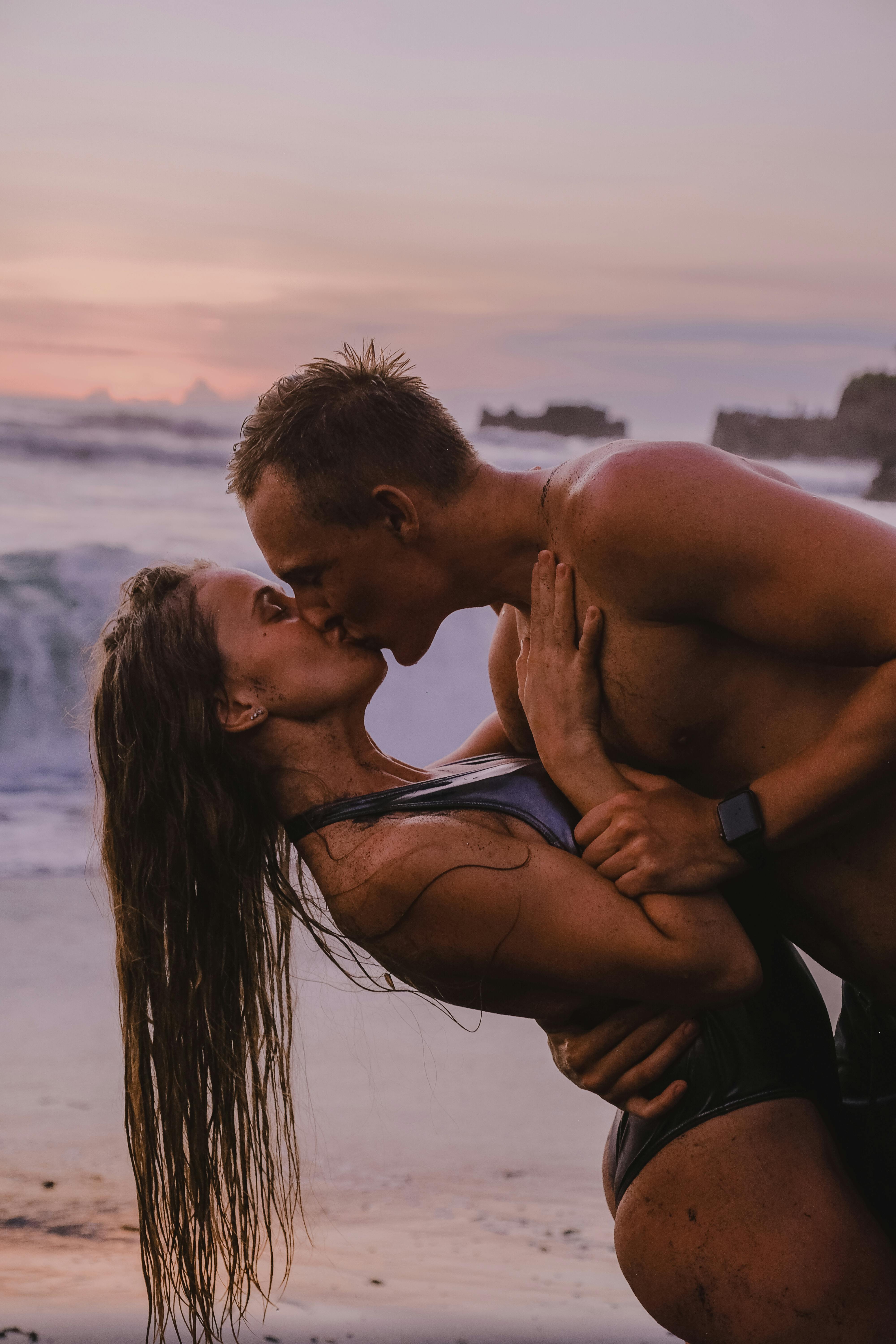 romantic couple kissing at the beach