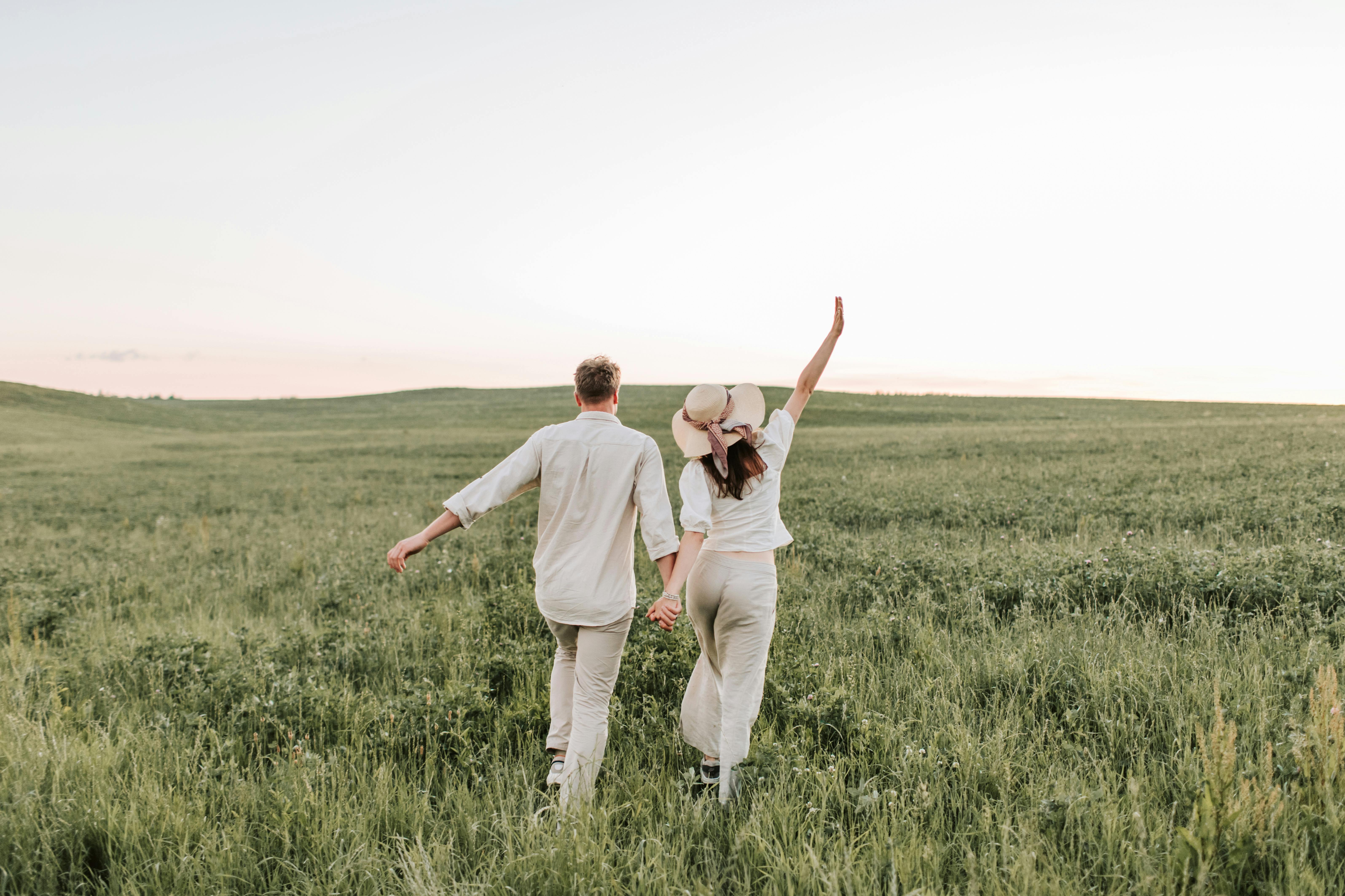 a couple walking on the grass field