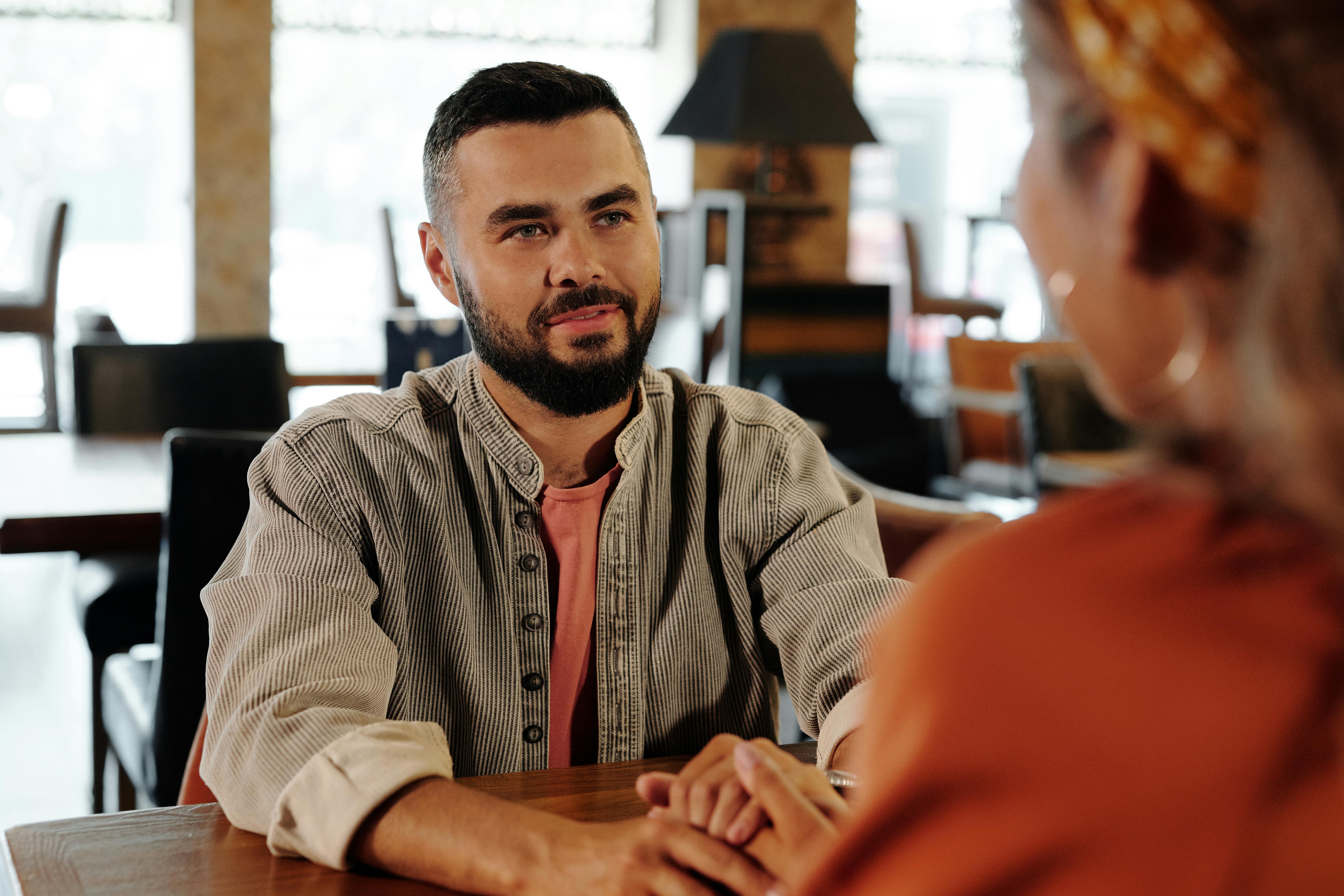 man in gray dress shirt sitting on chair