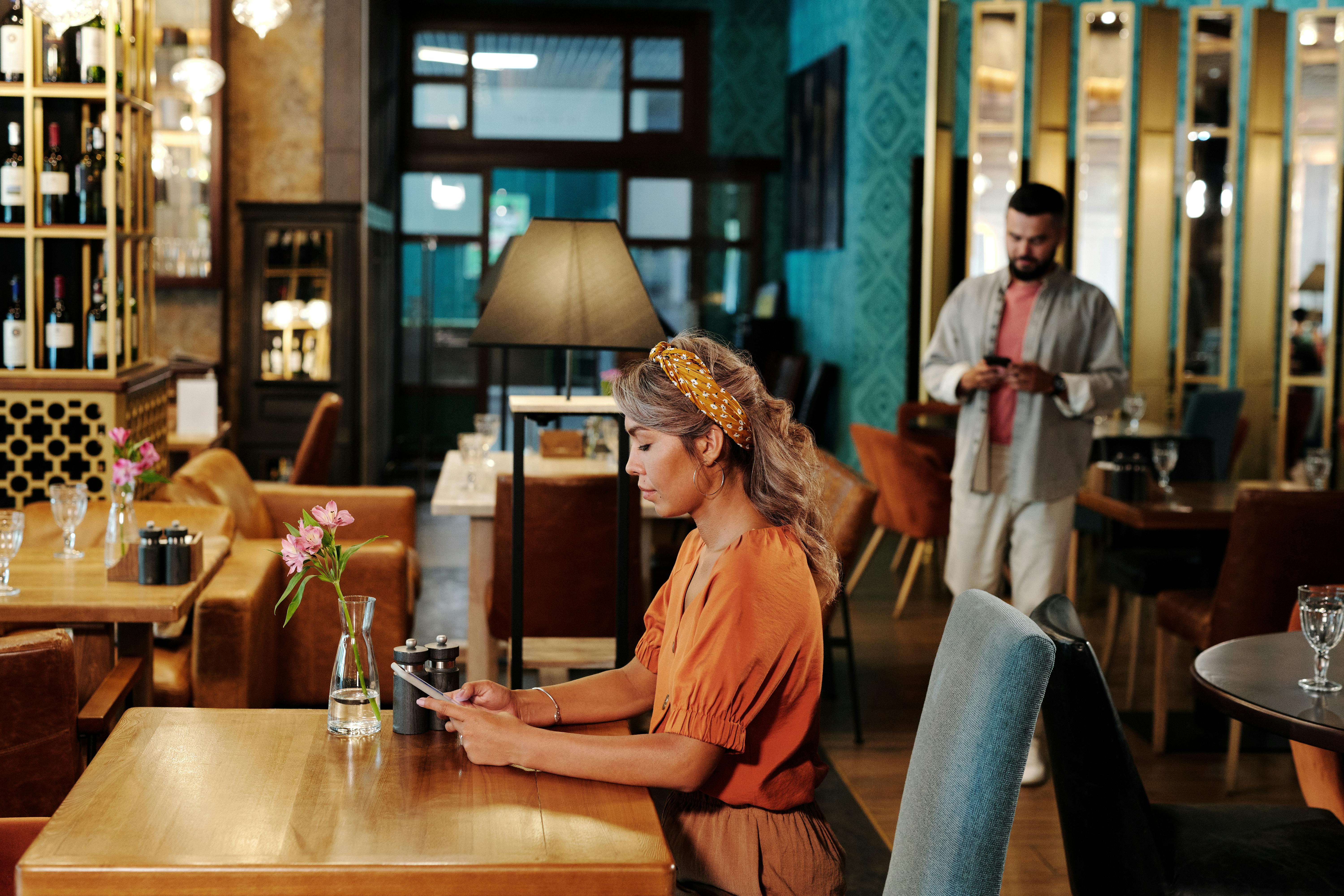 man and woman busy using their cellphones in the restaurant