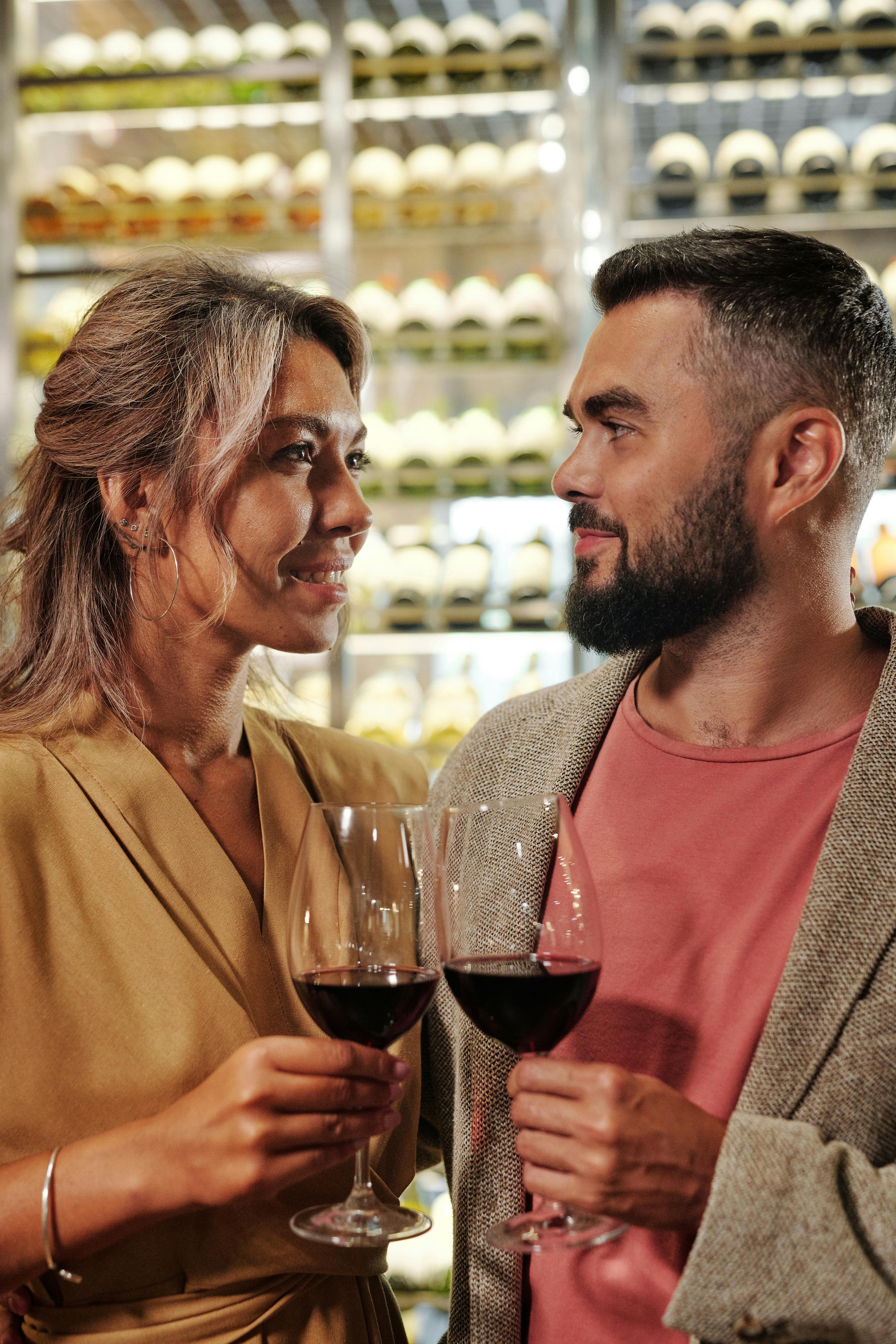 couple toasting with red wine glasses