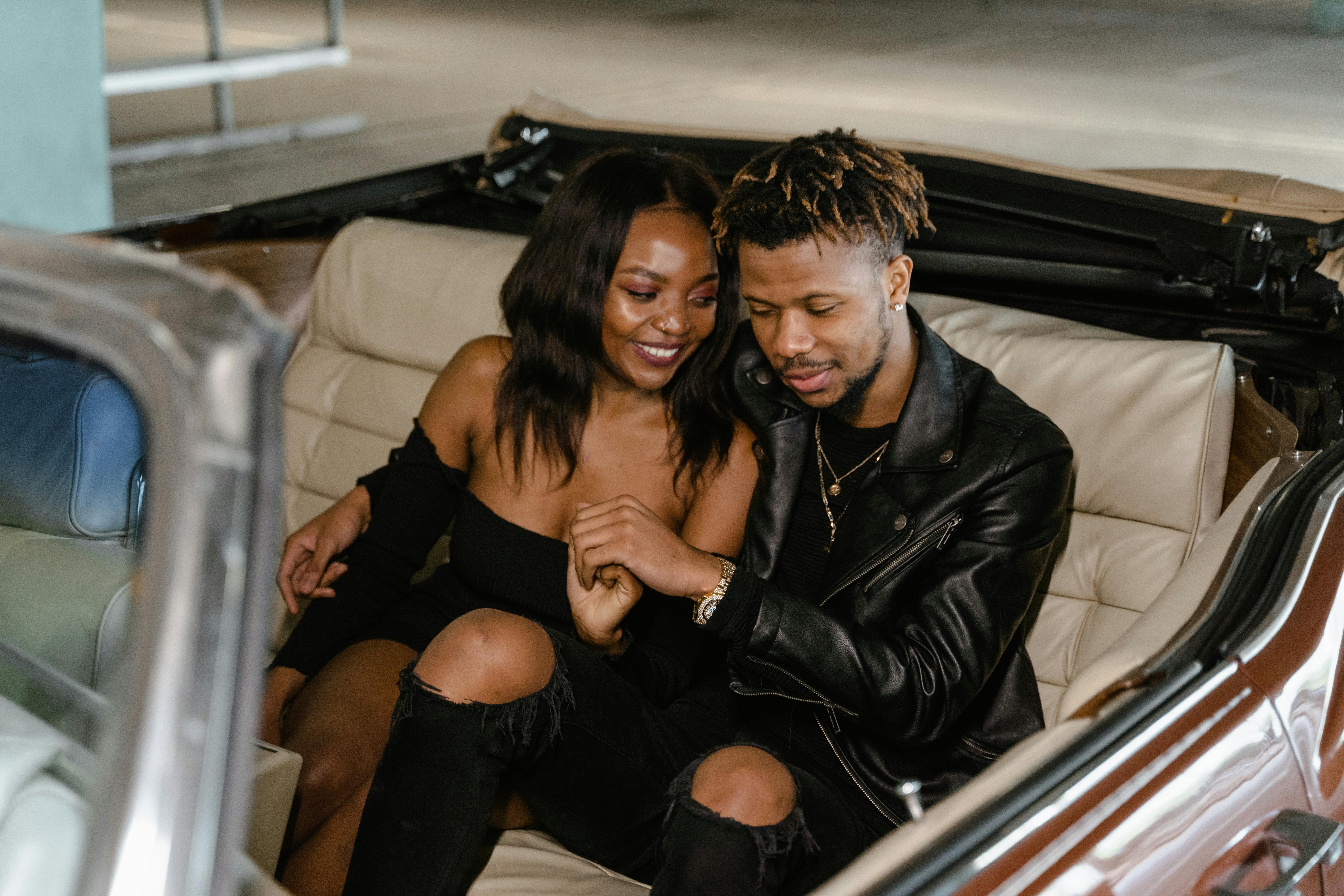 couple sitting on a car