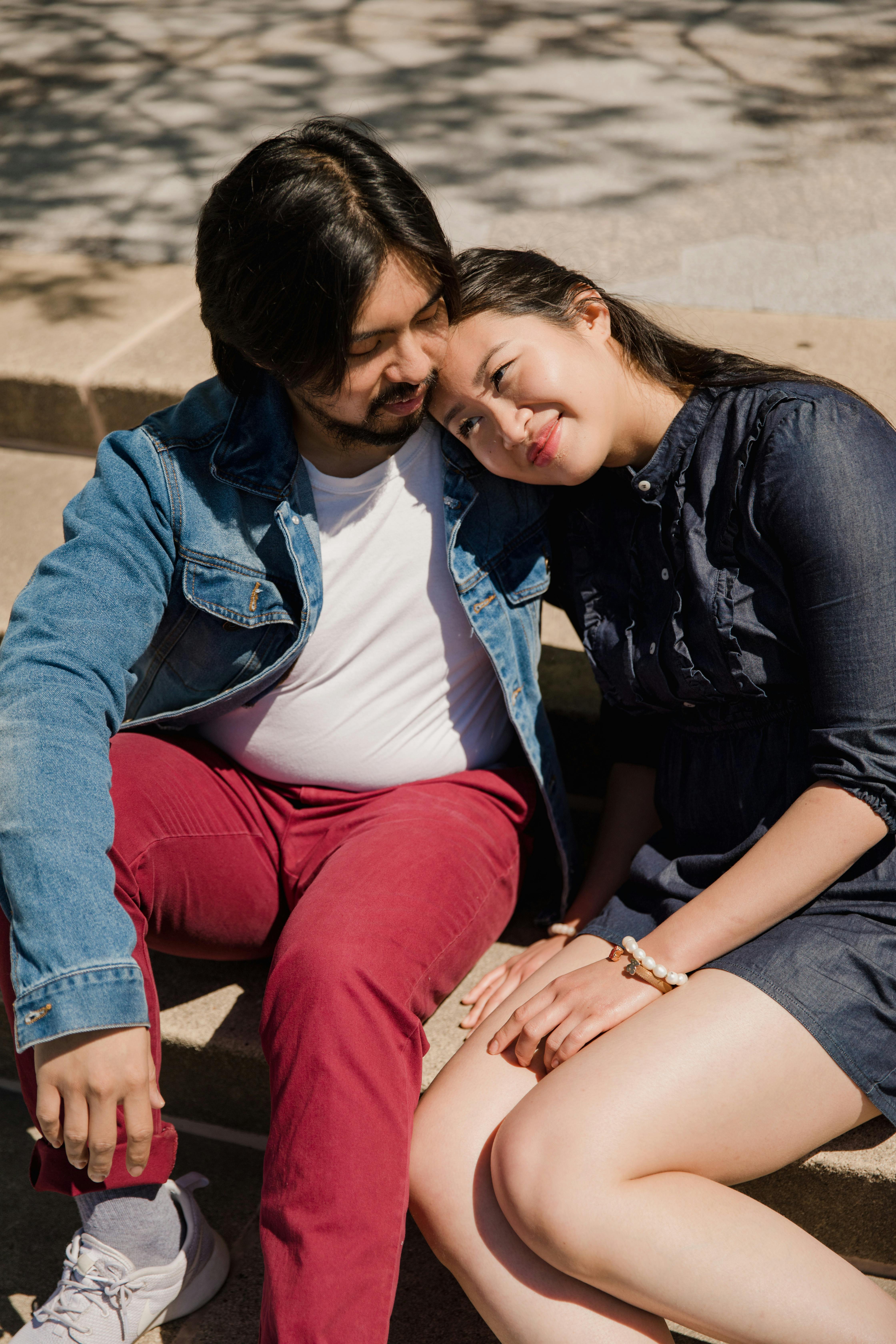 a woman leaning on a man s shoulder