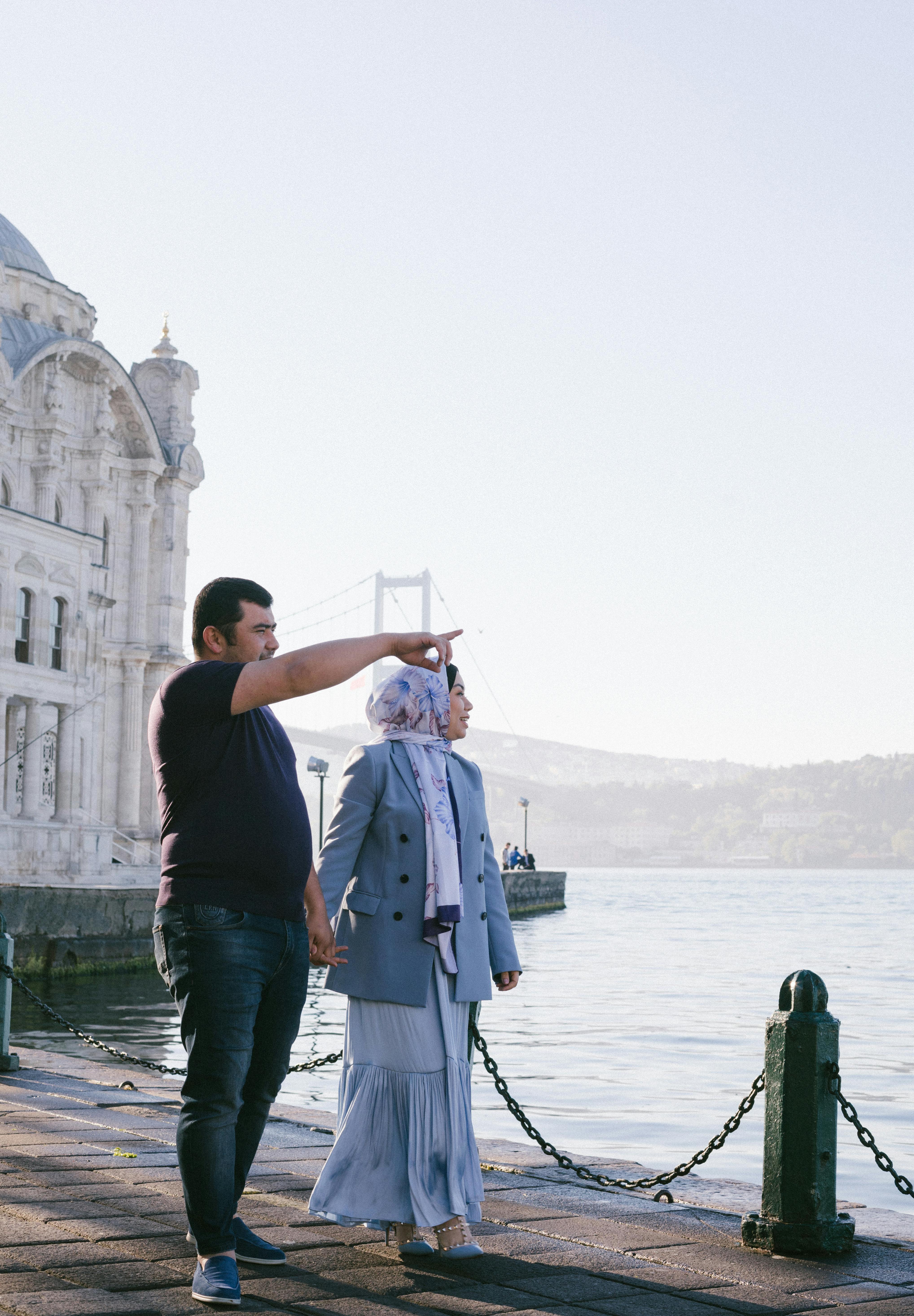 a couple sightseeing while holding hands