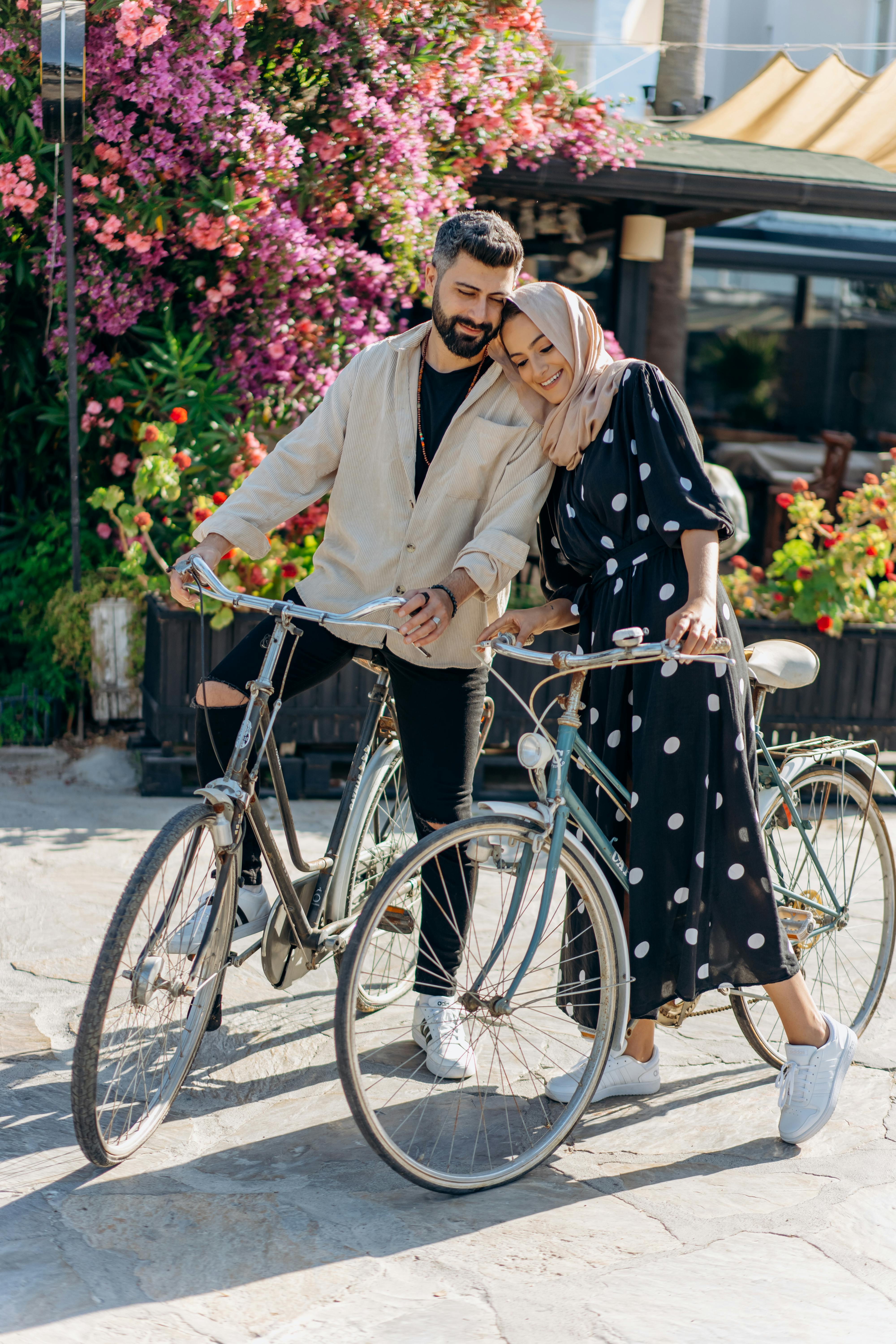 a lovely couple riding on bicycles