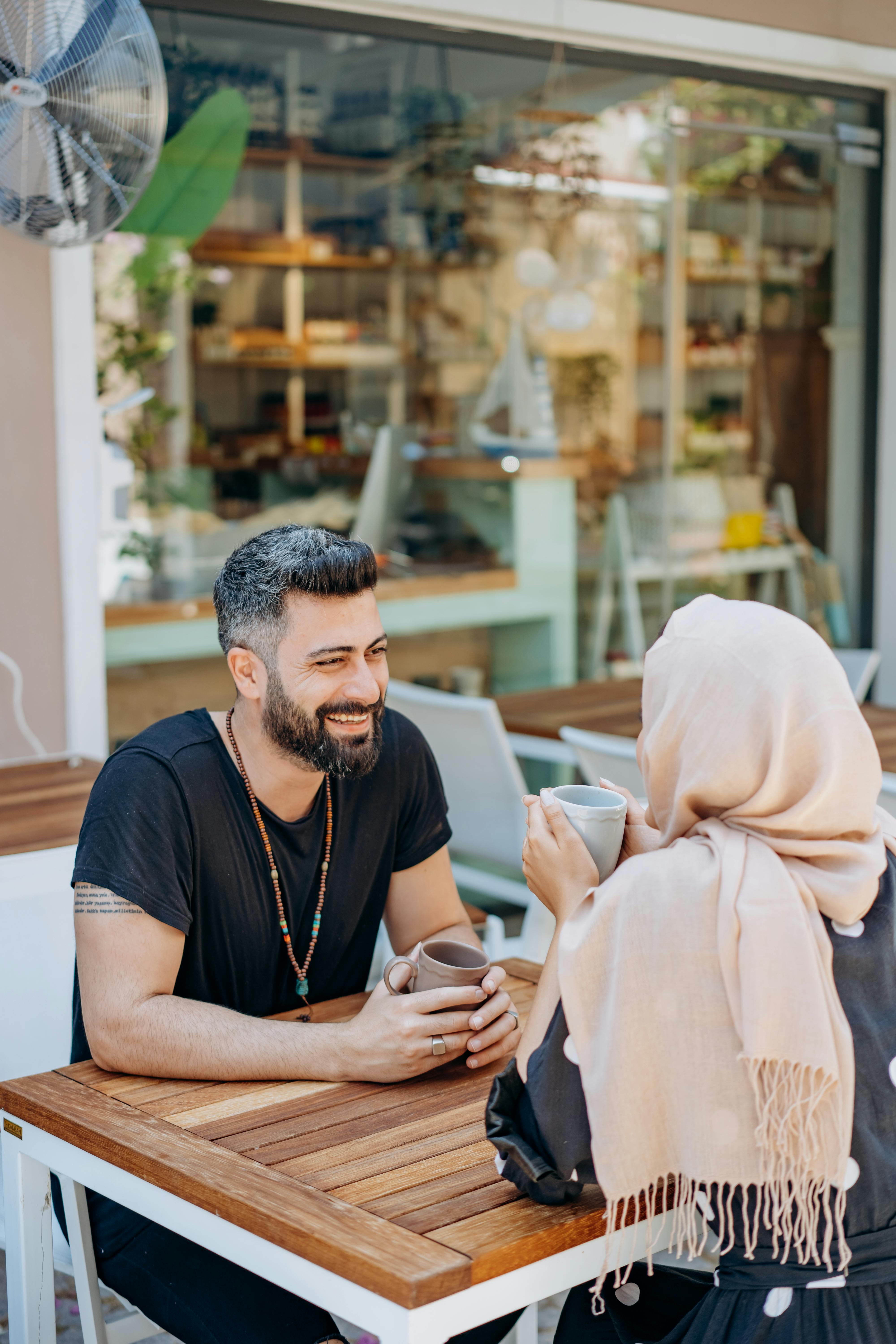 man having a date with a woman wearing head scarf