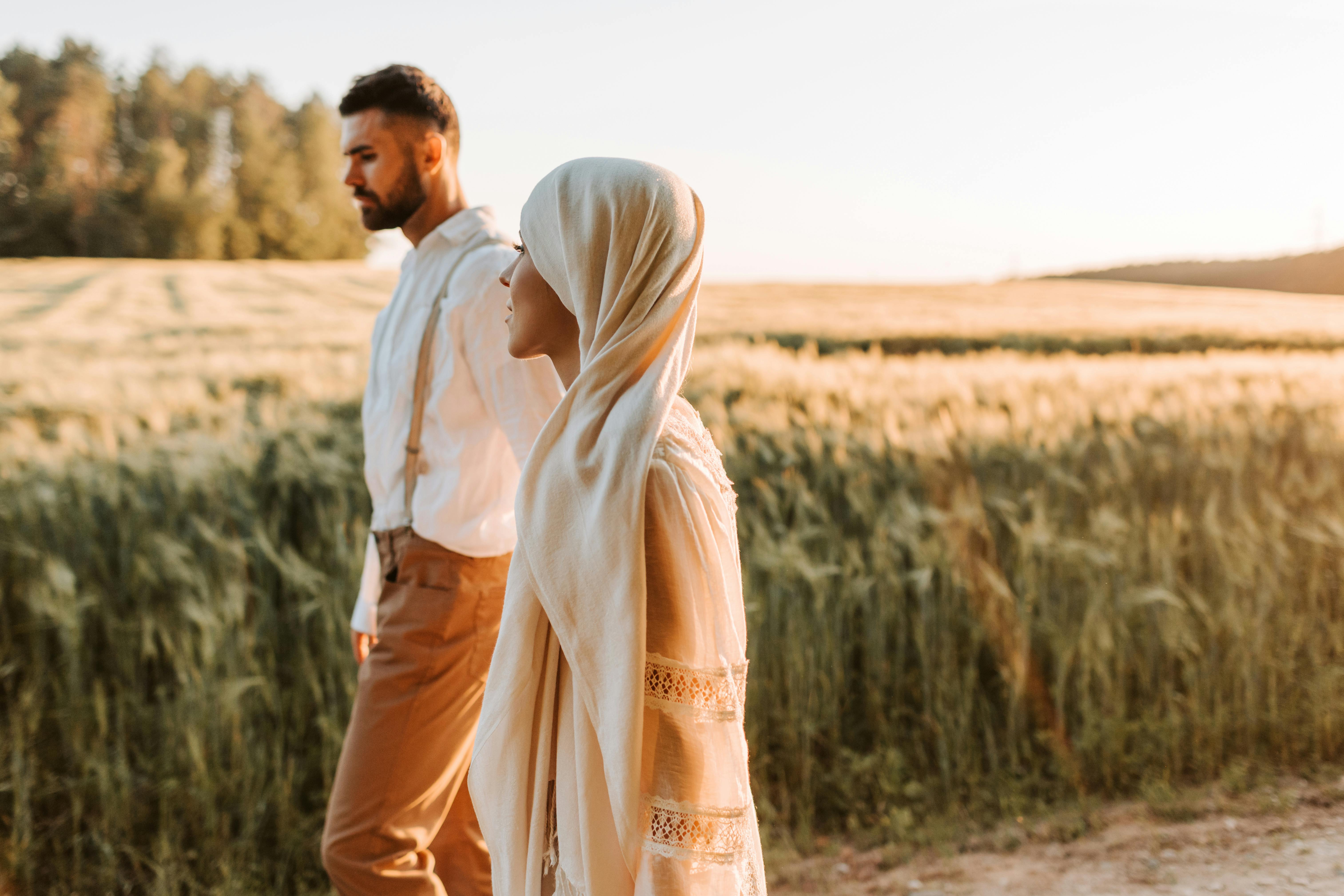 a couple walking on the grass field