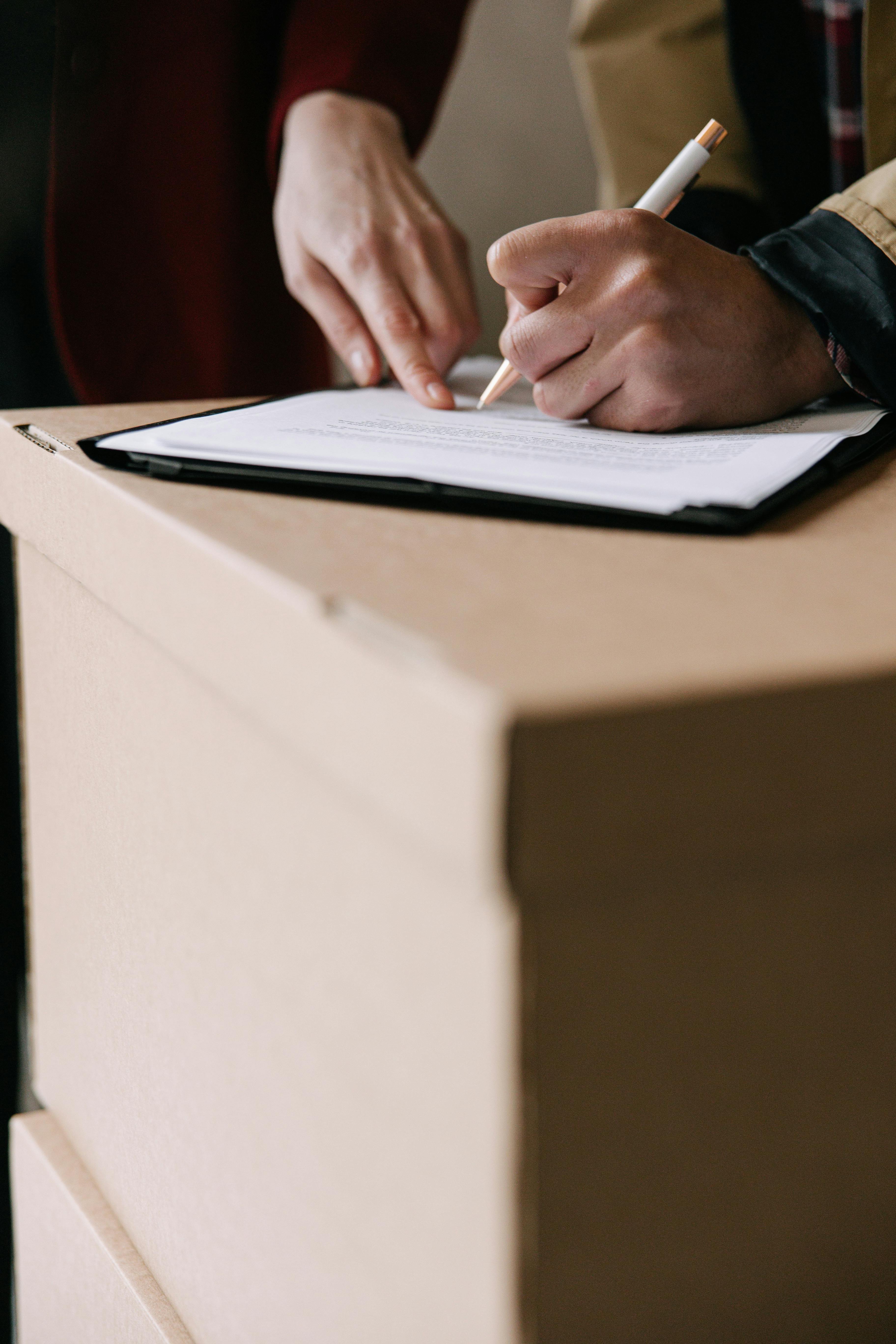 person writing on white paper