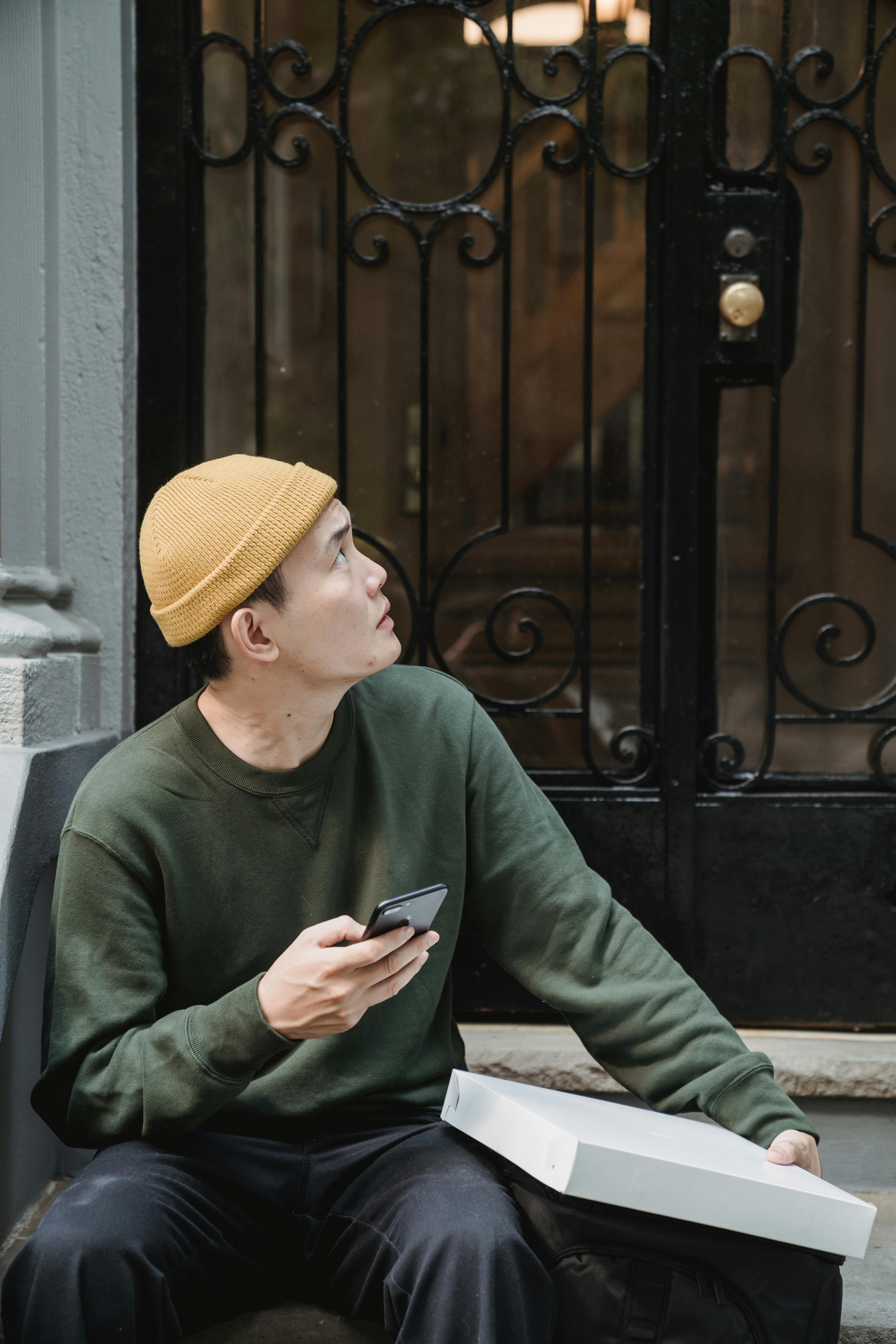 man sitting door pants