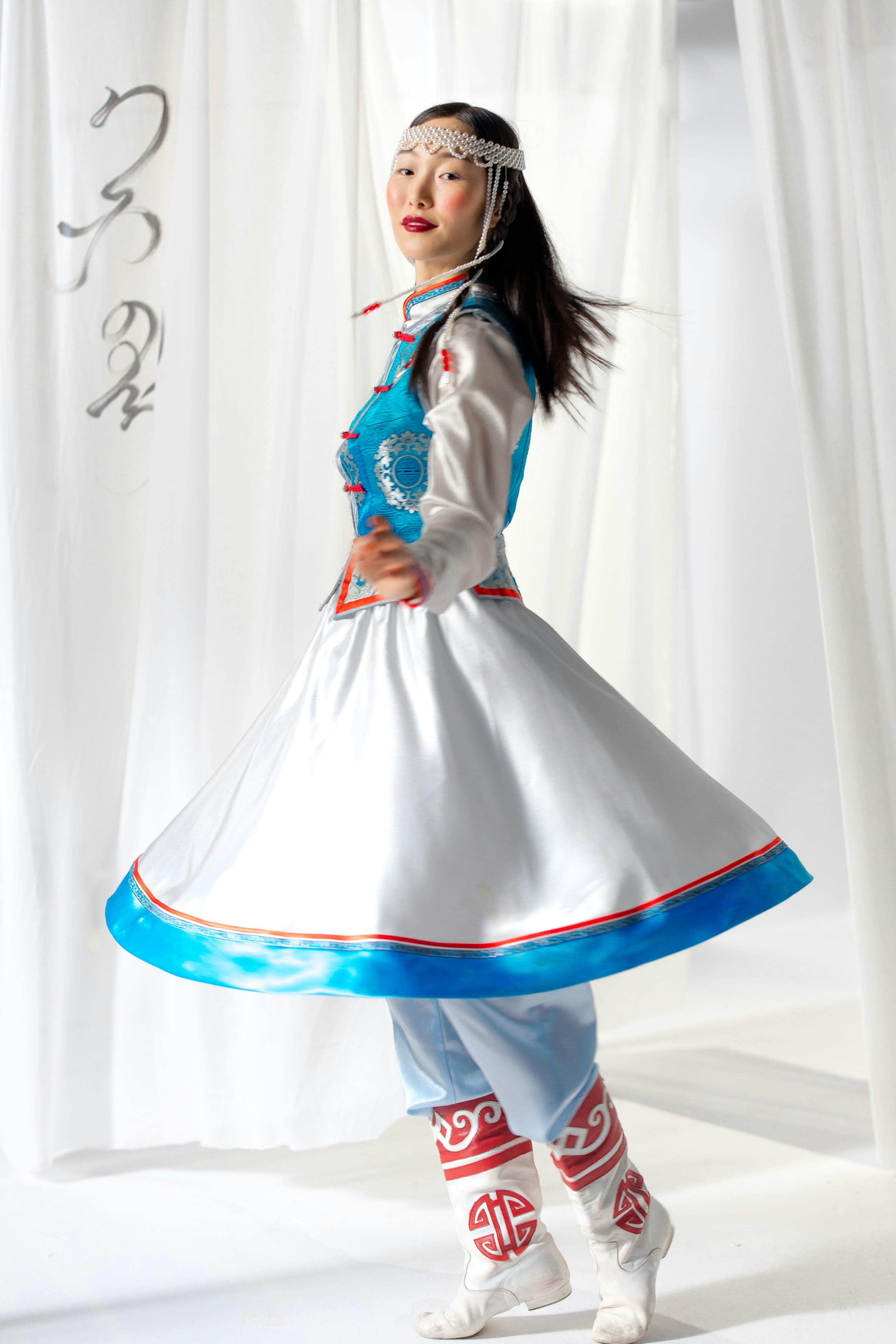 woman in traditional clothing spinning around