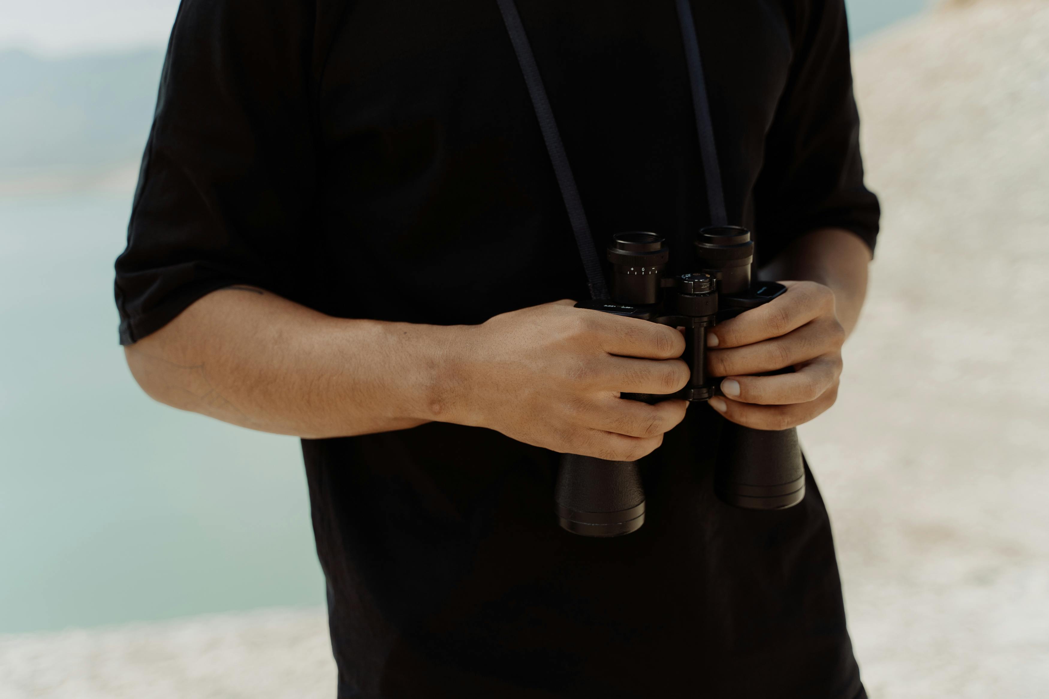 man holding binoculars