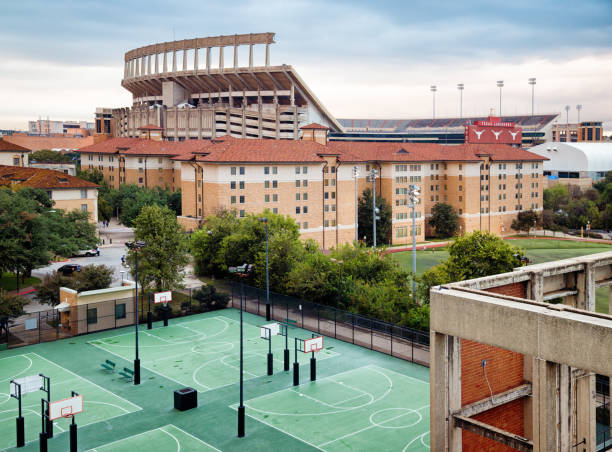 Austin Darrell K Royal Texas Memorial Stadium with University residences Austin Darrell K Royal Texas Memorial Stadium with University residences and basketball courts in the foreground must be darrell stock pictures, royalty-free photos & images